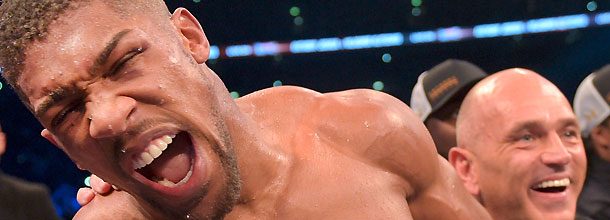 Anthony Joshua looks happy after a victory in the boxing ring